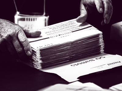 hands stacking ballots